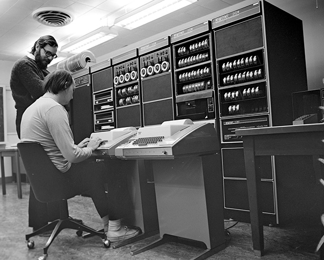 Ken Thompson (sitting) and Dennis Ritchie at PDP-11-s